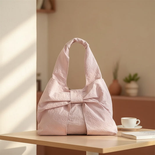 Jelly Studio pink nylon slouchy tote bag with a large bow detail on the front. Casual style.