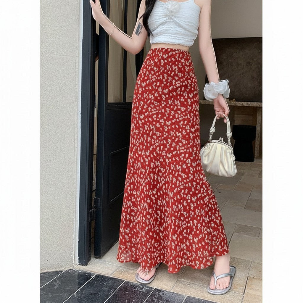 Jelly Studio red midi skirt with a ditsy floral print and flared hem. A woman wears it with a white crop top.