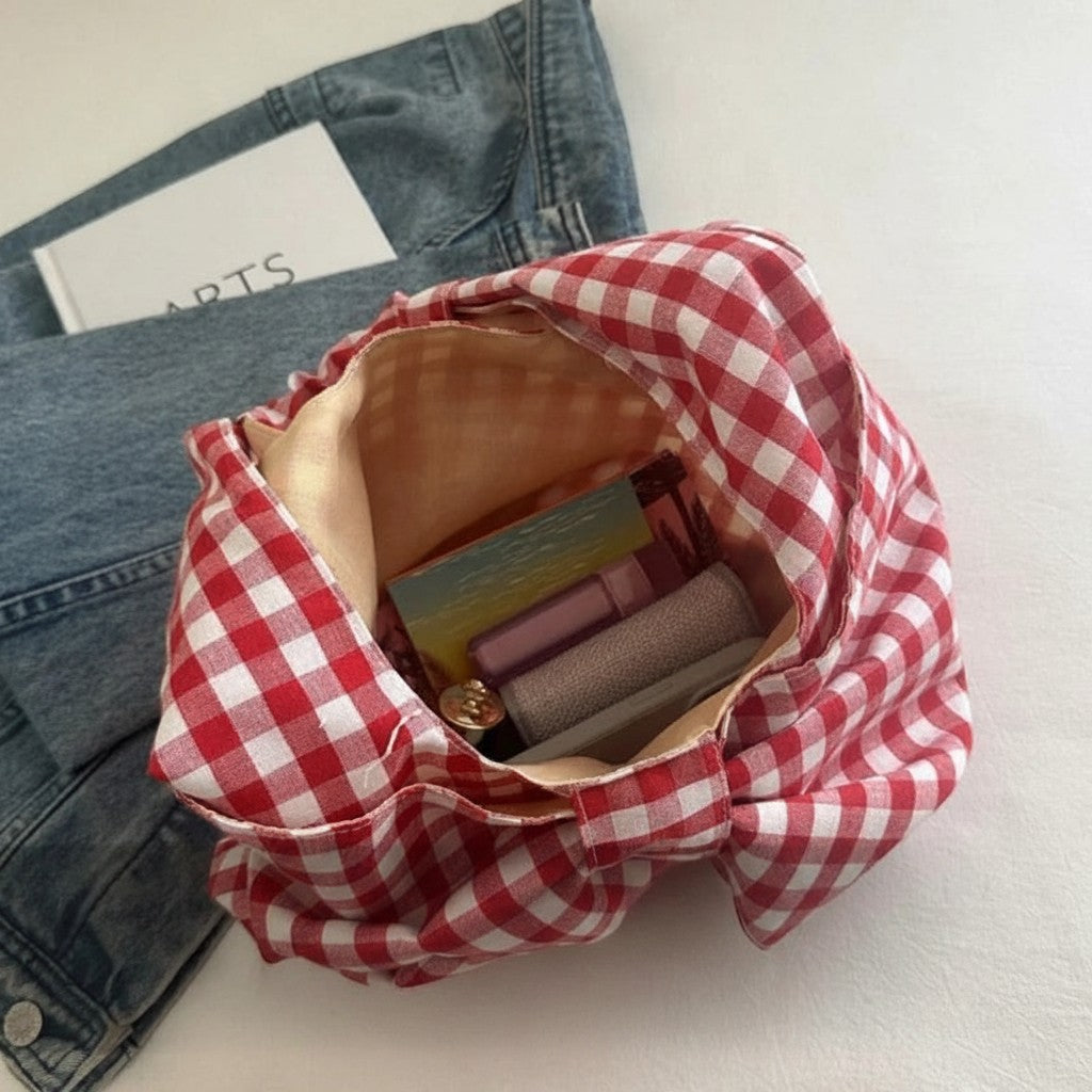 Jelly Studio red and white gingham fabric tote bag with a large main compartment and two handles. Holds books and cosmetics.