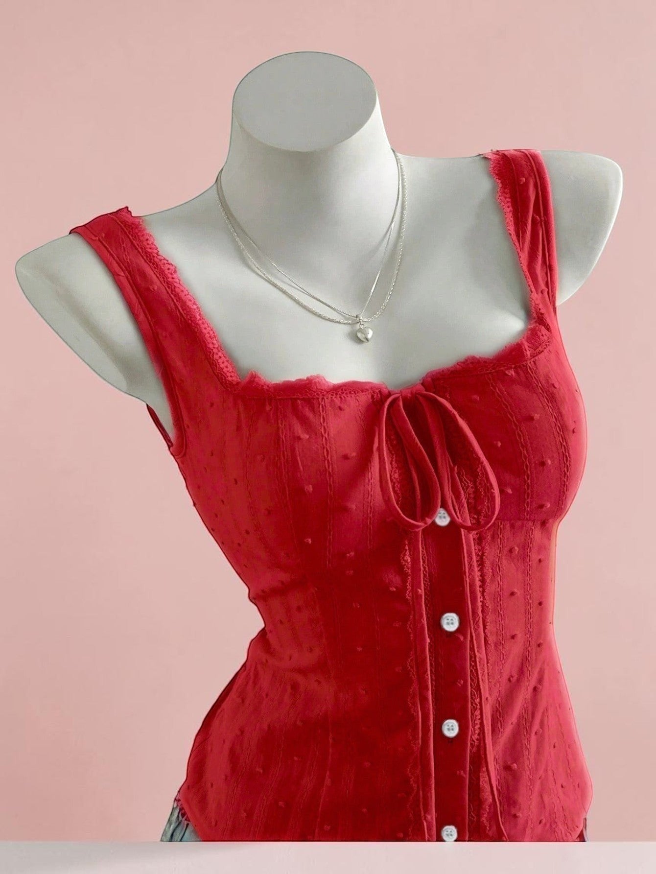 Jelly Studio red textured corset tank with lace trim, tie front, and button details.