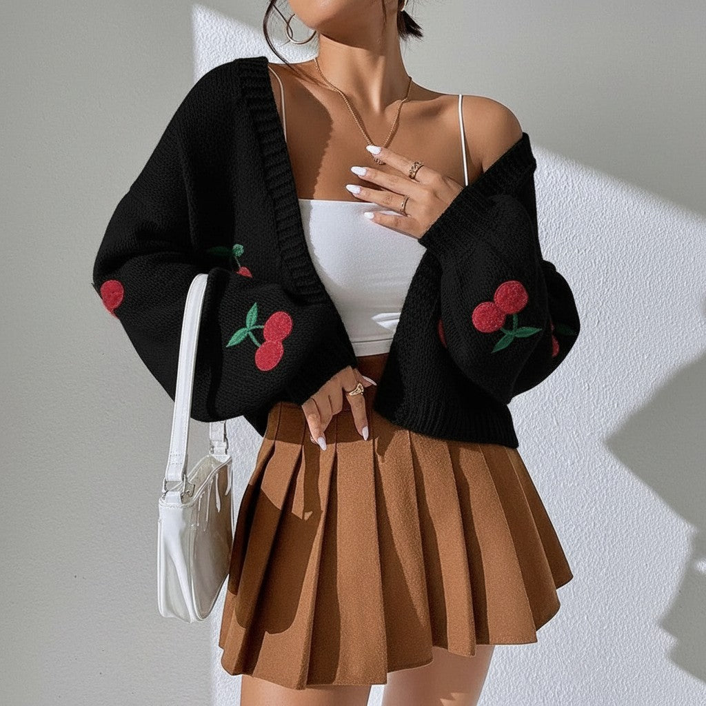 Jelly Studio white knit cardigan with cherry embroidery, paired with a white camisole and brown pleated skirt.